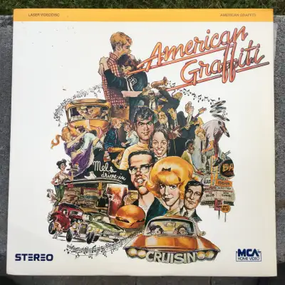 Starring Ron Howard, Richard Dreyfuss, Paul Le Mat, Harrison Ford (Star Wars) Cindy Williams, Charle...