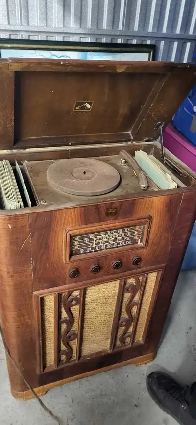 I'm selling an RCA Victor antique stereo record player and radio unit, a vintage piece of audio equi...