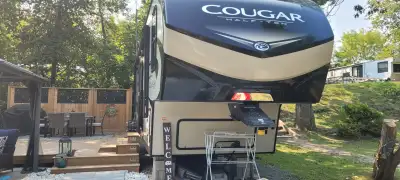 Beautiful 32 ft Keystone Cougar 5th wheel trailer for sale at Sandbanks River Country Resort, steps...