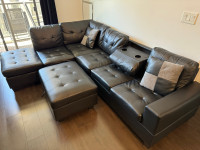 Faux Leather Sectional with fold down cup holder, ottoman and pi
