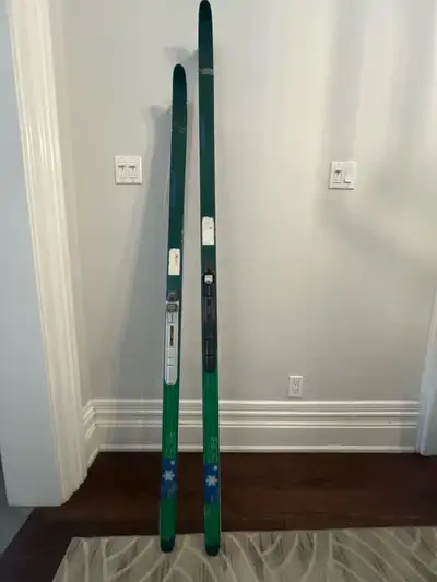 Two pairs of Salomon cross country skiis. Waxless, fish scale skin skiis. SNS boot bindings. One pai...