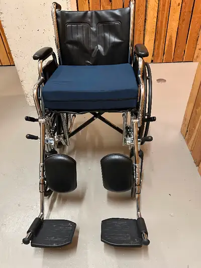 Near new rarely used wheelchair with a padded cushion.