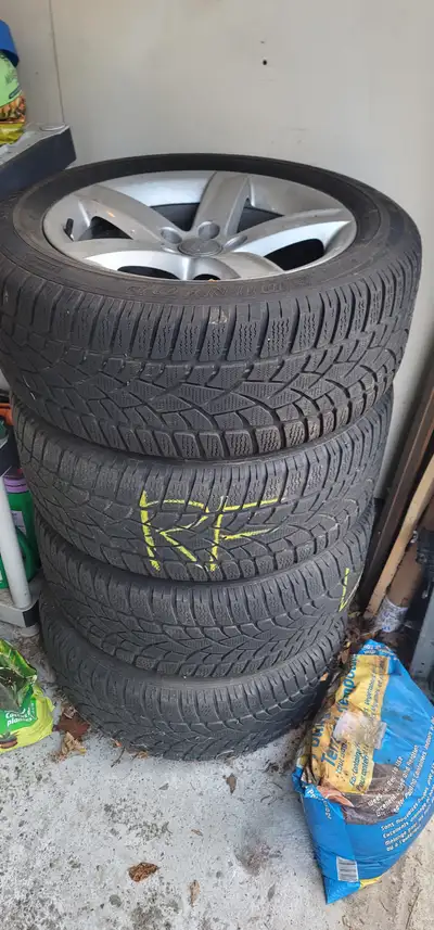 A complete set of Dunlop SP Winter Sport 3D winter tires 225 / 55 R17 97H mounted on OEM Audi alloy...