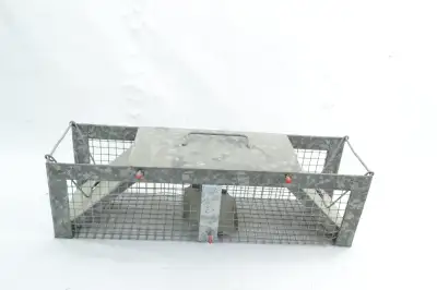This is an unused Havahart medium 4 by 4 inch double door trap made too capture small game alive and...