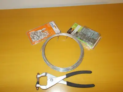 3/4 roll of wire almost full pack of eye bolts full pack of white rivets tool for installing rivets