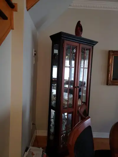 China hutch/ glass cabinet with 5 glass shelves and interior overhead light. 28.5”W x 76”H x 10”D