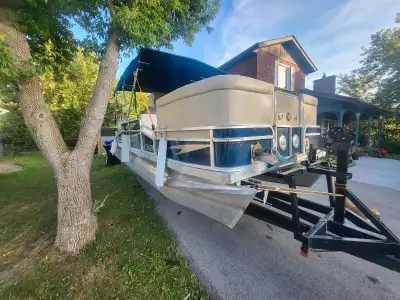 Pontoon with trailer Bathroom and sink 50hp Mercury 2 stroke runs great Full canvas enclosure Ready...