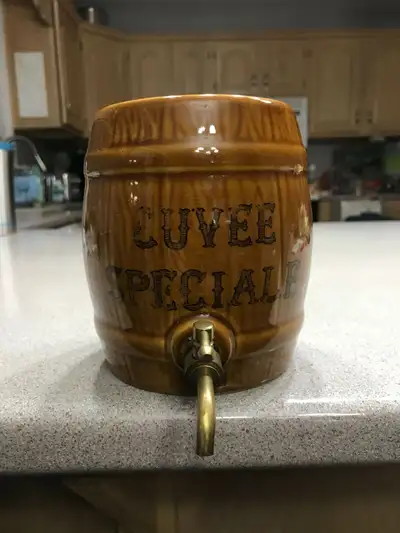 It has a brass tap and measures 5 1/4 inches high and approximately 4 1/2 inches across; it has a lo...