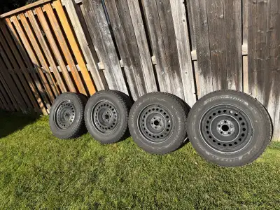 Selling a set of Bridgestone Blizzak 235/65R17 winter tires mounted on rims. Just purchased last yea...
