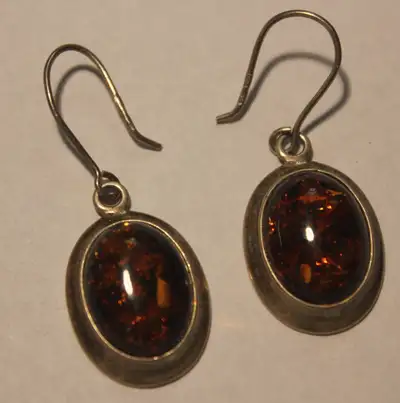 Stunning Cognac Baltic Amber oval dangle earrings in 925 sterling silver. Amber size x 2: 14 mm x 12...