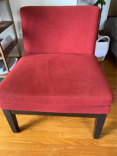 Original West Elm slipper accent chair upholstered in a vibrant red fabric. It's got a simple, moder...