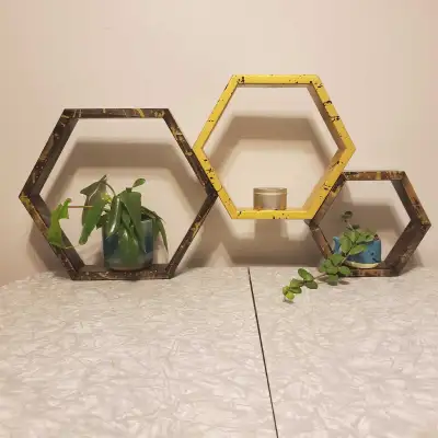 Trio of pine hexagon shelves. The large and small shelves are stained with black stain and spattered...