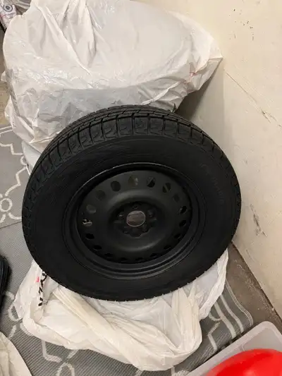 Complete set of four Yokohama iceGUARD G075 studless winter tires mounted on black 18-inch steel rim...