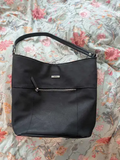 Never used faux leather handbag Good amount of space inside, 2 water bottle compartments. Delivery a...
