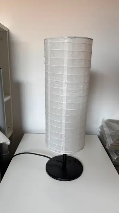 Charming white/black table lamps that gives off a soft, cozy glow through its rice paper shade—perfe...