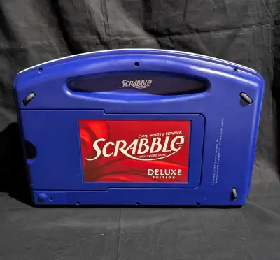 Scrabble Deluxe Edition board game with raised grid. Complete. The game board folds for easy travel...