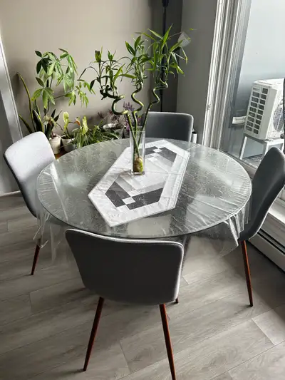 Round Table, wooden legs and Glass Table Top With 4 gray chairs All in good condition Used barely Ta...