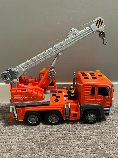 Toy construction crane truck with crane that goes up and down, lights and sound. In great condition....