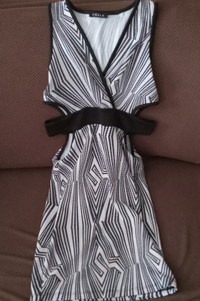 Small black and white patterned dress with side cutouts.