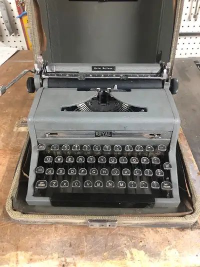 Royal Quiet Deluxe portable typewriter with case. Fair condition.
