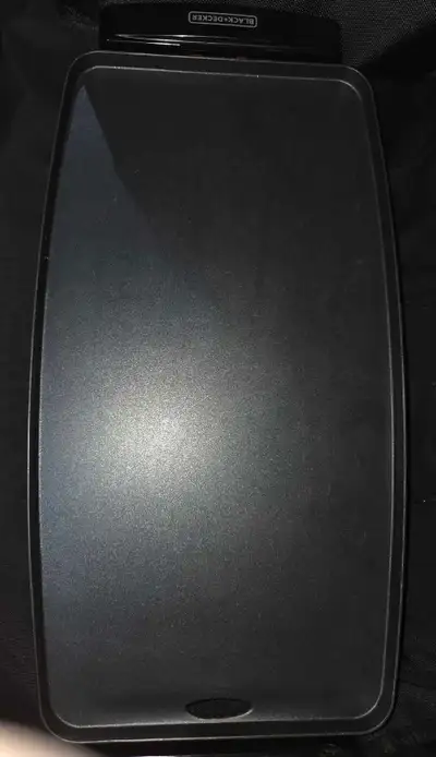 This is a Black + Decker electric griddle featuring a large, non-stick cooking surface.
