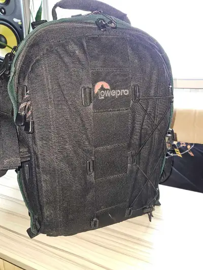 This is a used Lowepro high end camera bag backpack designed to securely hold and transport your cam...