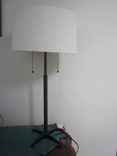 Table lamp with black metal base. Approx. 30" H and 12" W. Dual bulbs.