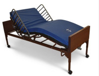 Hospital bed with mattress and rails