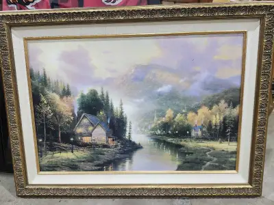 Enhance your living space with this Thomas Kinkade framed art, a serene depiction of a cabin by the...