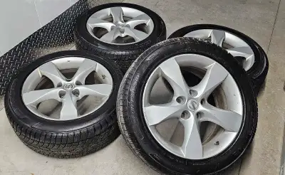 Set of 4 nissan altima original rims with winter tires good condition some curbrashes and scratches...