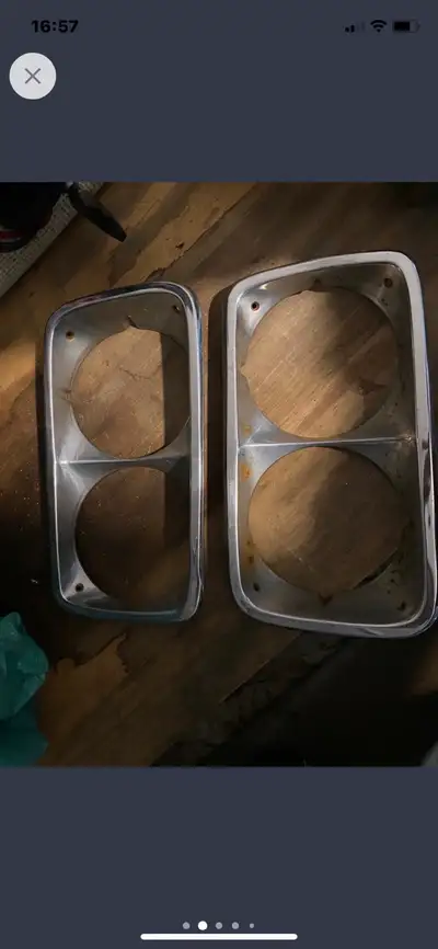 These are a pair of used 1969-72 GMC pickup grille trim rings. They show signs of wear consistent wi...