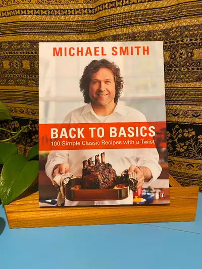 Autographed copy of CHEF MICHAEL SMITH’S Back to Basics cookbook, featuring 100 simple classic recip...