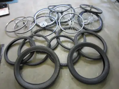 Assorted bicycle wheels and tires for sale, mostly 26 inch but one 27.5 front rim left I set of 29 i...