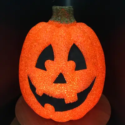 Add a touch of vintage Halloween charm to your home with this adorable light-up popcorn pumpkin, fea...