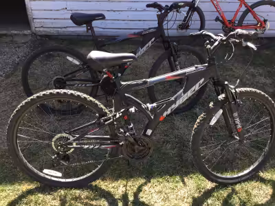 One of these bikes has been used twice, the other one has only been used once. One back tire is flat...
