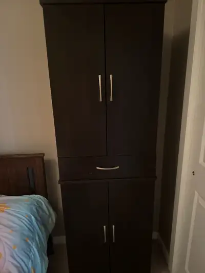 This is a used storage cabinet with a combination of shelving and drawer space, ideal for organizing...