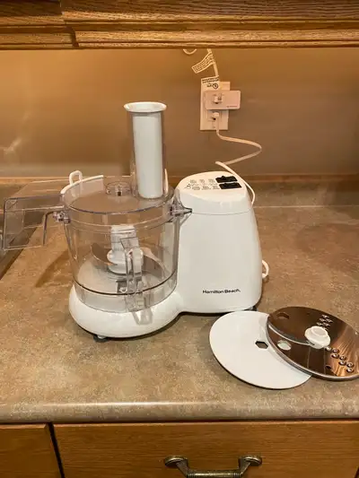 This is a used Hamilton Beach food processor, perfect for all your chopping, slicing, and dicing nee...