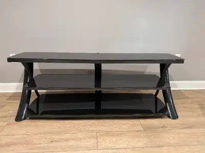 Sleek black entertainment unit in excellent condition. Spacious shelves for storage, sturdy design....