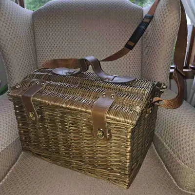 This never-used fine quality rattan picnic basket features a classic wicker design complete with a s...