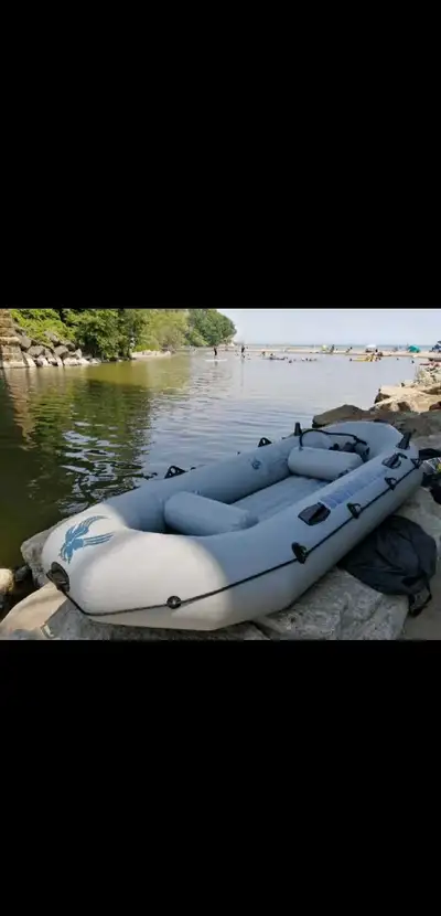 This is a used inflatable boat designed for recreational use on calm waters, featuring a durable con...