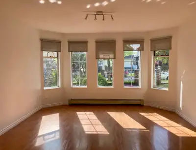 Bright, modern 2‑bedroom main‑floor suite for rent in a triplex house. The suite occupies about one-...