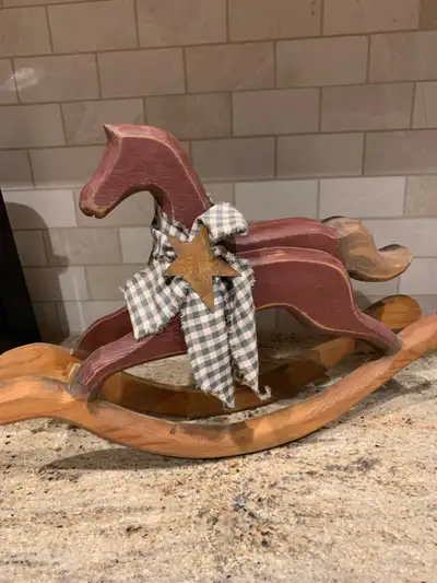 Unique, wooden rocking horse and colours of burgundy and green. Measuring 11 inches high and 16 inch...