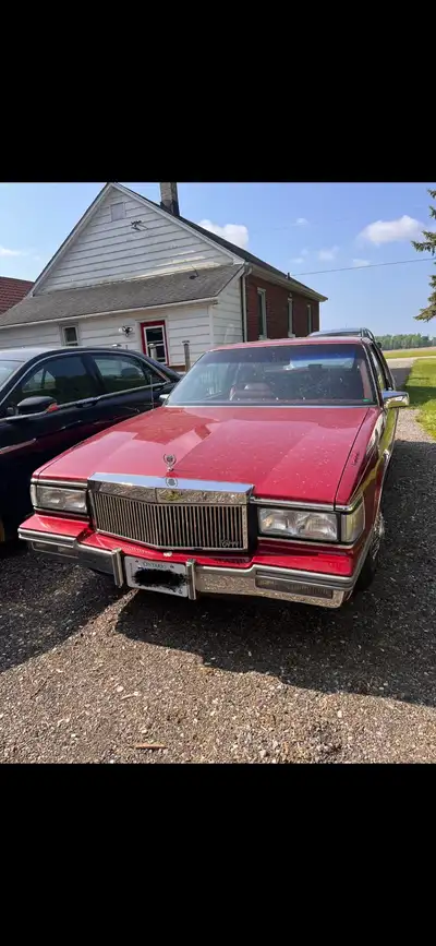 A beautiful example of 1987 Cadillac Couple DeVille. 72,000 original KMs. Red exterior with matching...