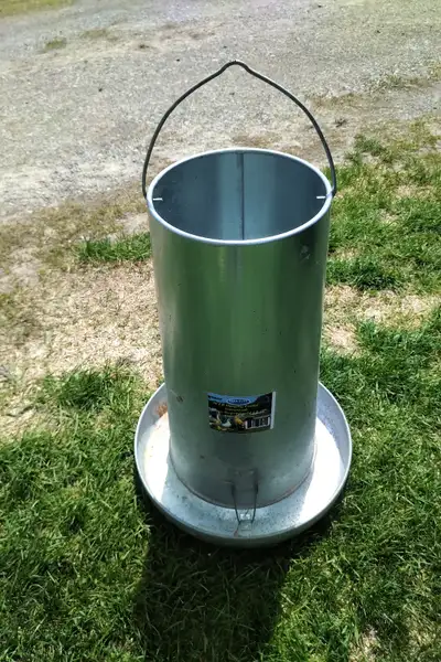 50 lb galvanized steel poultry feeder. Made in Canada. Quality feeder. With heat lamp and bulb. See...