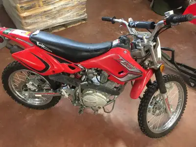 Baja Dirt bike stored in garage for years. Less than 50 km on bike, pictures show condition as new....