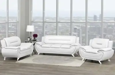 Upgrade your living space with this modern full white leather three-piece sofa set, which includes a...
