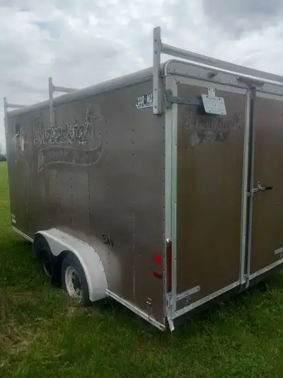 This tandem-axle Car Mate cargo trailer is ready for your next transport job, featuring exterior lad...