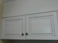 A pair of kitchen cabinet doors with hinges and knobs $35