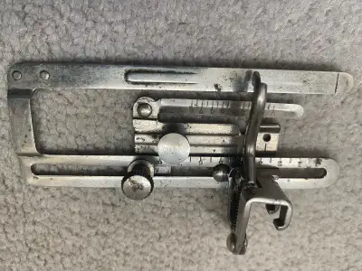 This vintage sewing machine attachment offers precision and control for detailed sewing projects. Th...