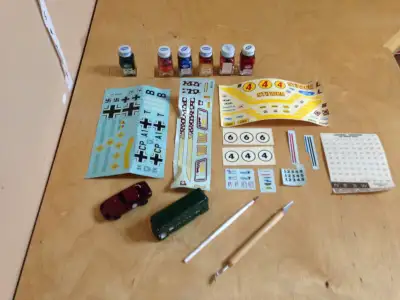 Lot of vintage model building items. Paint, water sticker sheets, 2 cars and a few tools. Much bette...